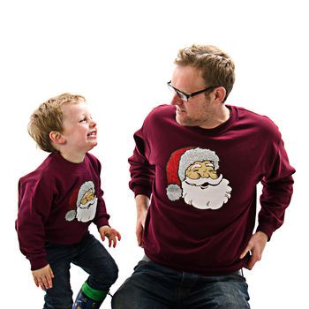 Christmas jumpers 2014. Dad and Son wearing matching Christmas jumpers, with Santa design.